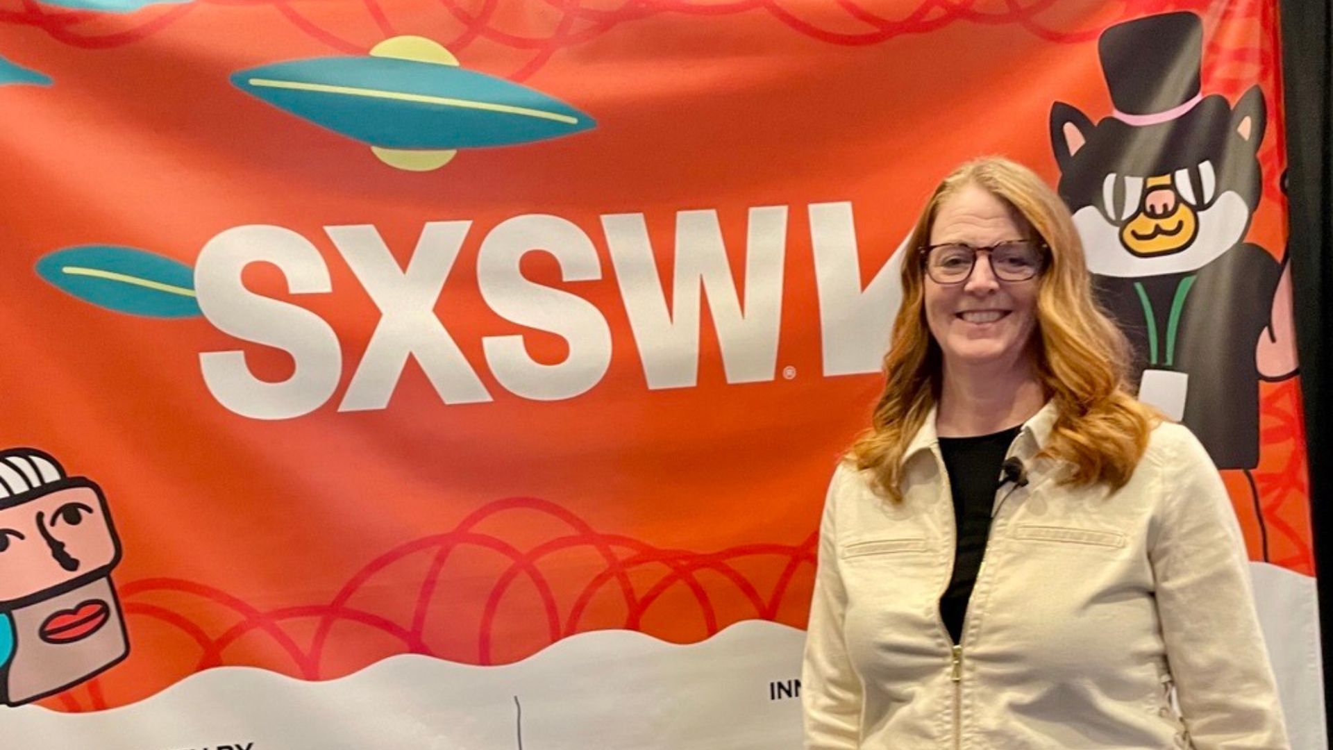 Dr Samantha Samaras, SVP, Science & Technology, Personal Care, Unilever, standing smiling in front of a bright SXSW conference banner.