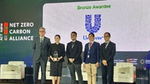 Unilever representatives receive a bronze award from the Net Zero Carbon Alliance.