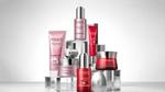 A selection of red and pink Pond’s skincare products in tubes and pots arranged in a pyramid shape.