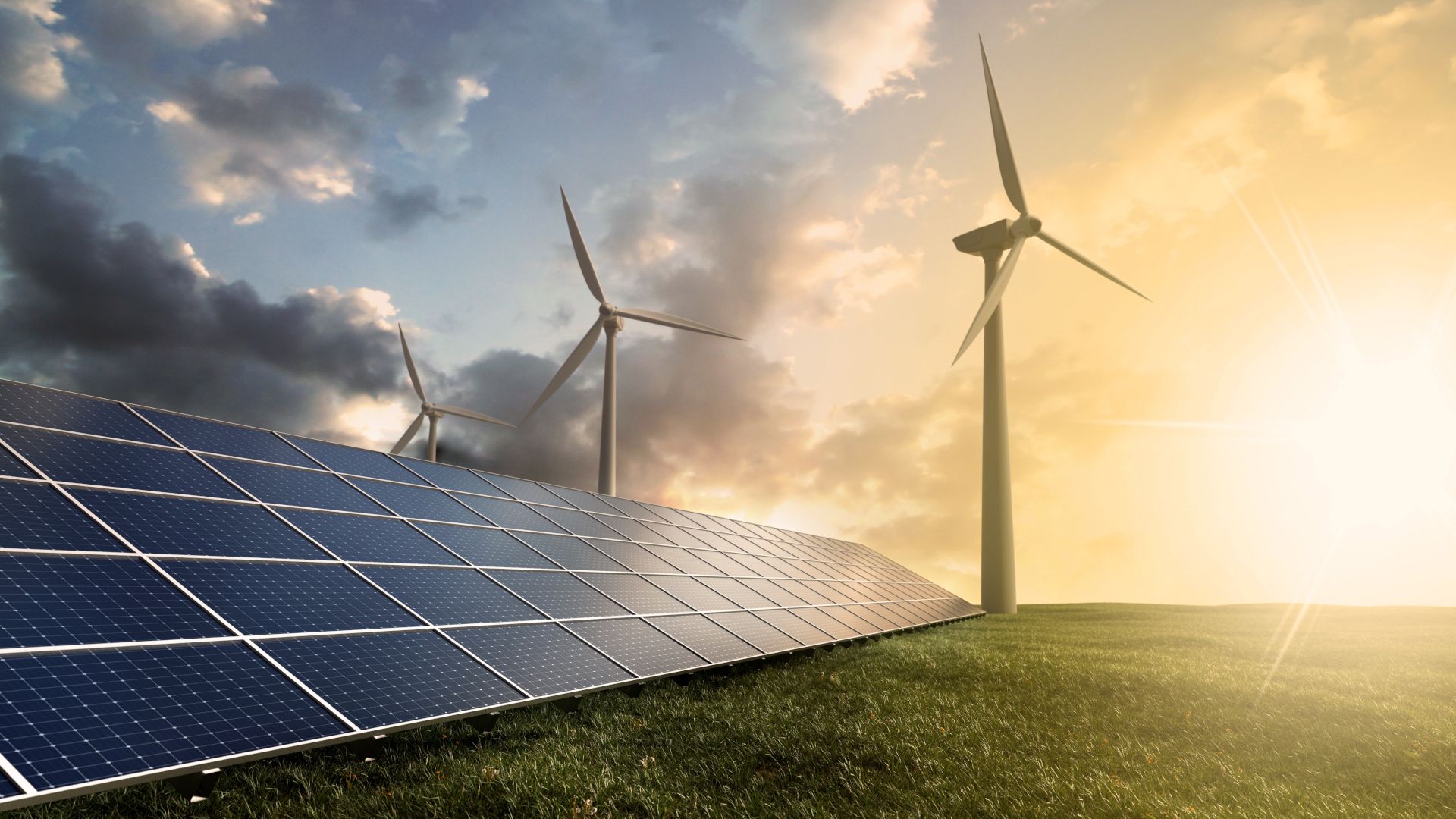 An image of solar panels and wind farms on a green field.