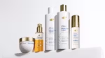 Five products from the Dove Damage Therapy range, designed to repair and strengthen damaged hair. Packaging is white with gold accents.