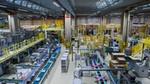 Image of a factory production line, with products on conveyer belts.