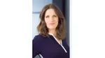 A photo of Dr Victoria Fraser, R&D Director for Dove. She is a white woman with brown hair and blue eyes, smiling at the camera.