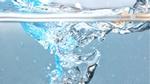 Close-up image of water splashing into a glass